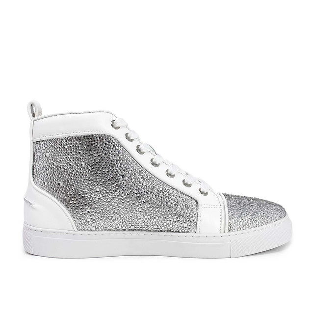High-top sneakers with a white leather and suede base covered in silver glass rhinestones featuring a textured surface and white laces.