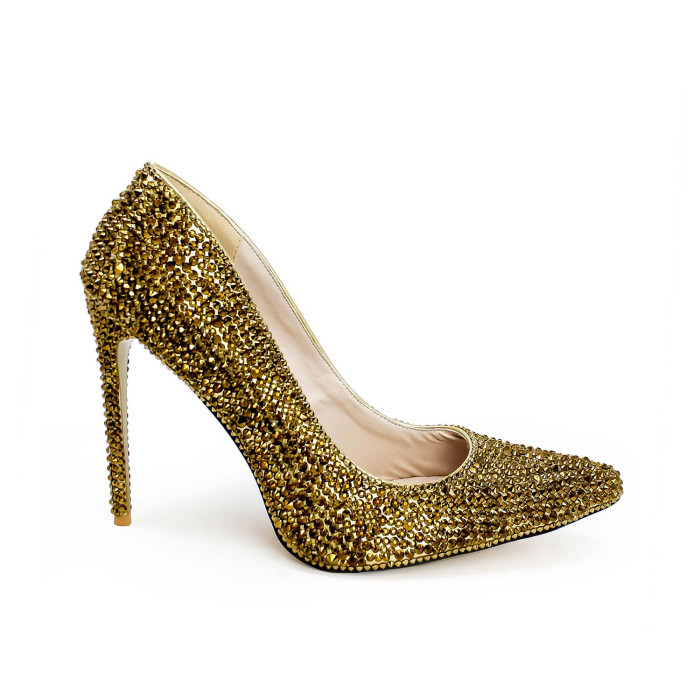Gold high heel shoe covered in shimmering glass rhinestones with a pointed toe and a rubberized sole.