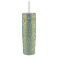 A tall silver tumbler covered in rhinestones with a clear straw and a smooth shiny surface.