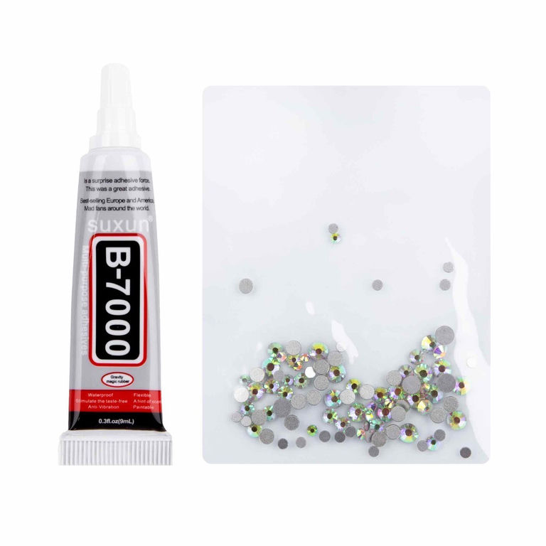 A&#x20;tube&#x20;of&#x20;clear&#x20;adhesive&#x20;beside&#x20;a&#x20;clear&#x20;pouch&#x20;filled&#x20;with&#x20;silver&#x20;and&#x20;iridescent&#x20;rhinestones&#x20;of&#x20;various&#x20;sizes&#x20;and&#x20;shapes.